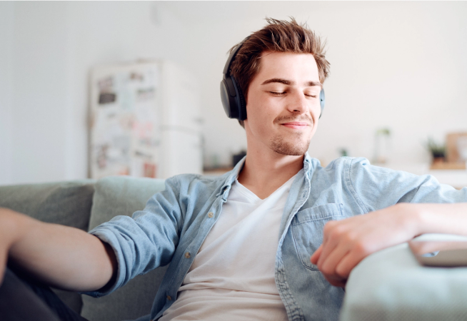 Young man sitting on sofa and relaxing
