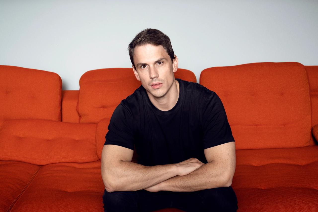 CEO Christian sitting on a red couch