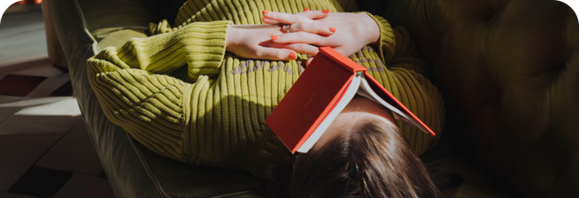 Woman with book on her face