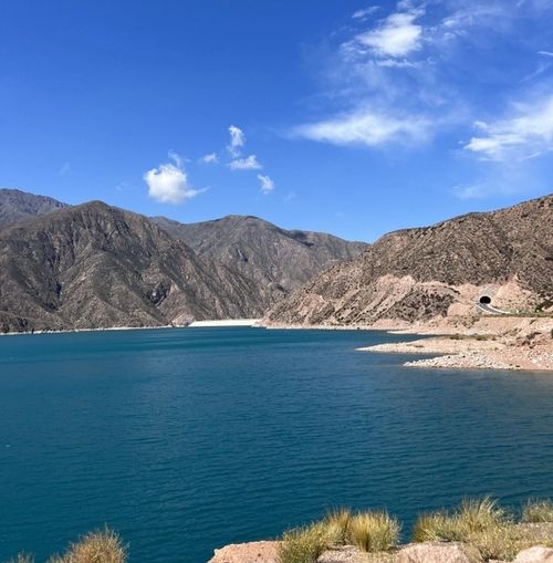 a large body of water with mountains in the background