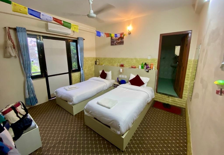 a hotel room with two beds and a ceiling fan .