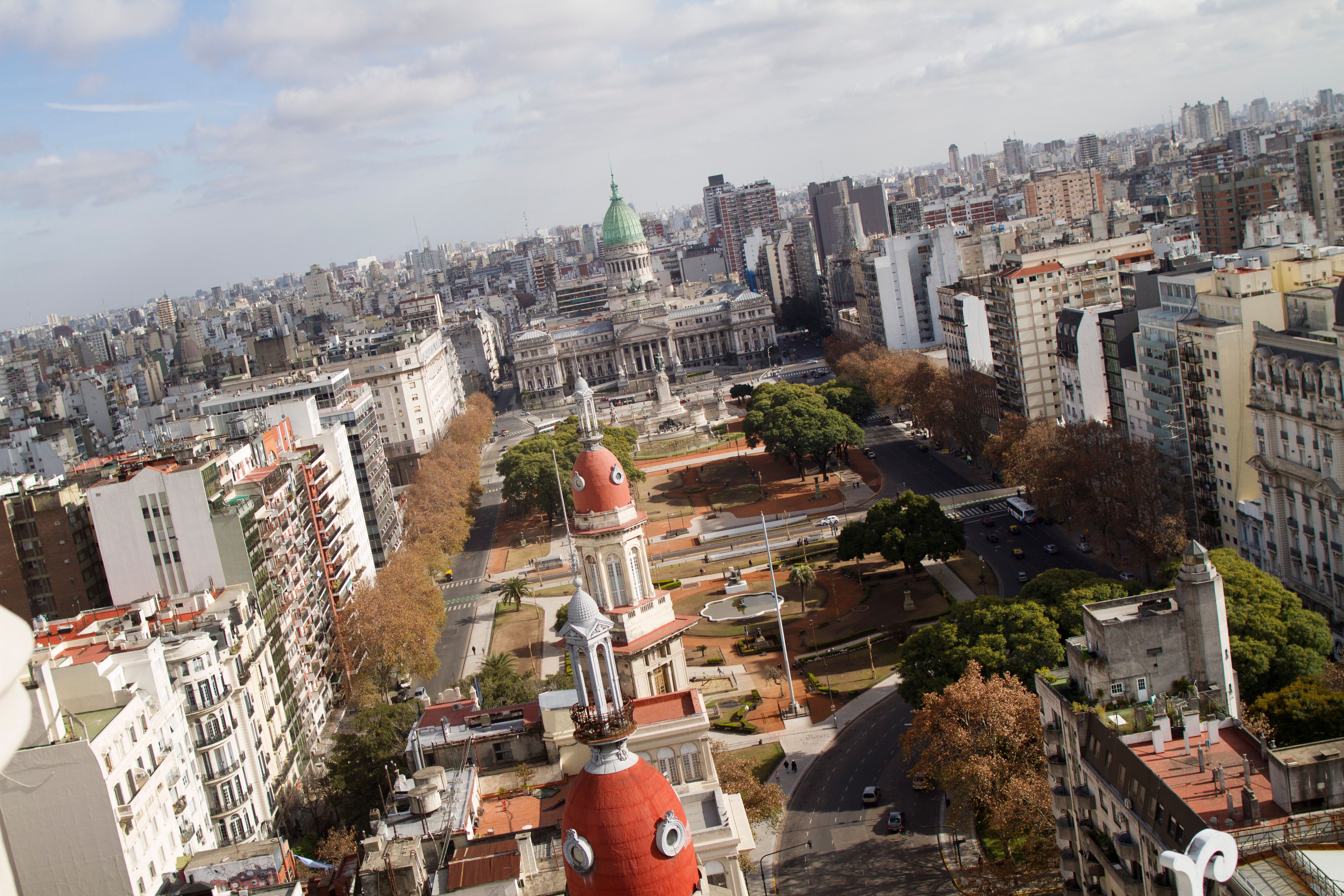an aerial view of a city with a red building in the middle .