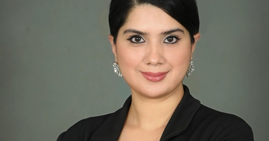 a woman in a black jacket with her arms crossed