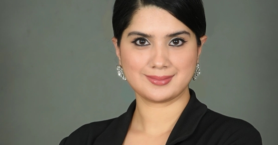 en kvinne i en svart jakke med armene i kors