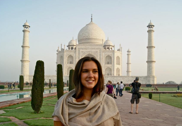 en kvinde står foran taj mahal i Indien.
