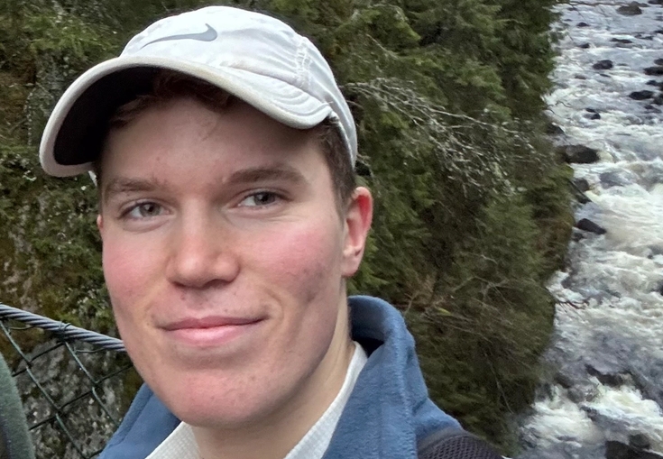 a man taking a selfie in front of a river