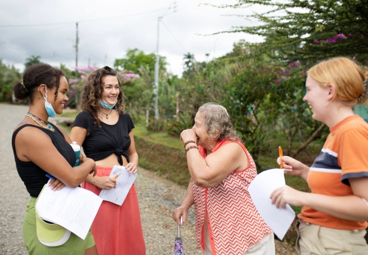 two monkeys are sitting on a tree branch .