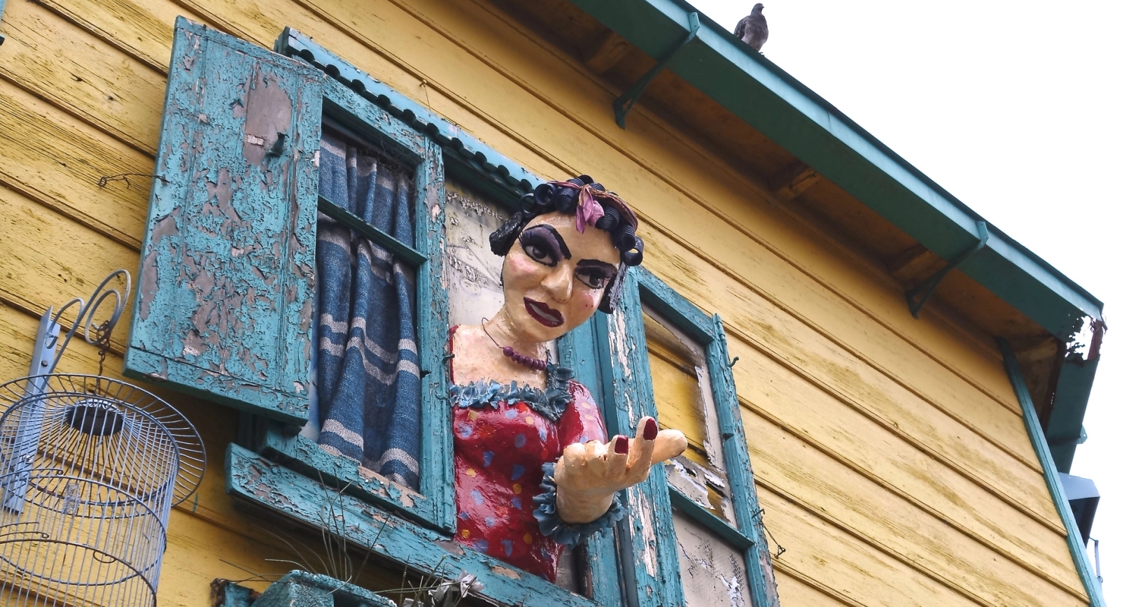 a statue of a woman is looking out of a window .