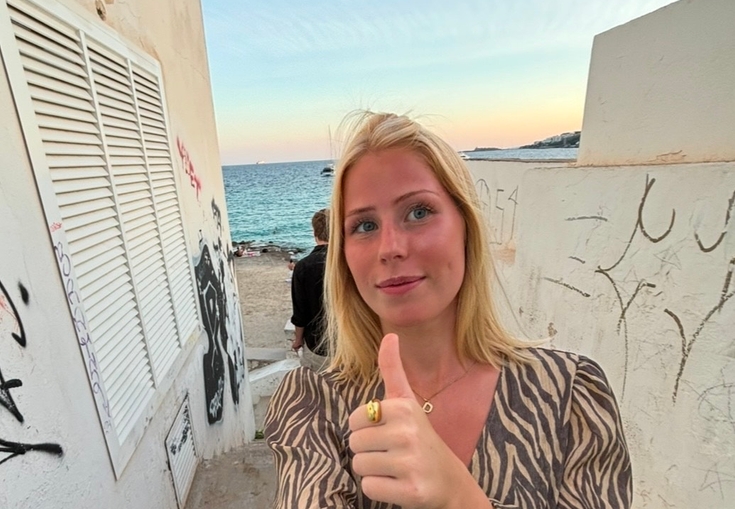 a woman in a zebra print top gives a thumbs up