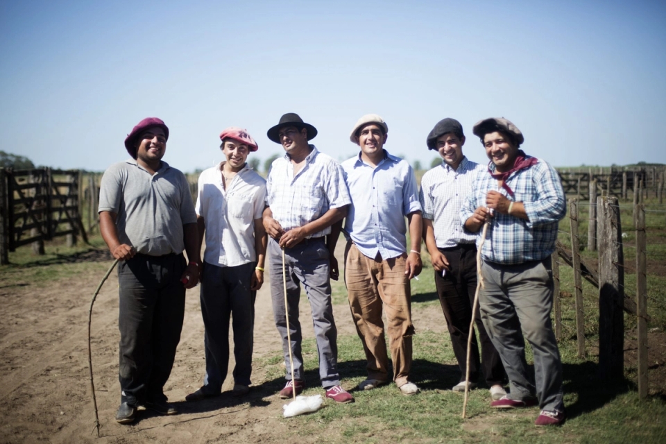 a group of men are standing next to each other in a field .