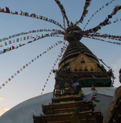 a very tall building with a lot of flags hanging from it