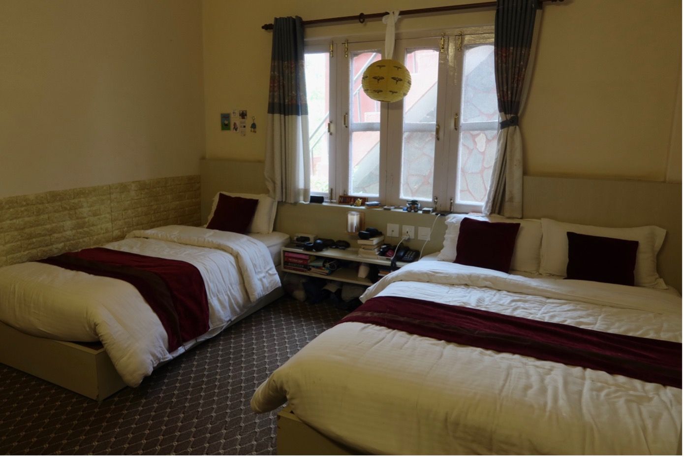 a hotel room with two beds and a window .