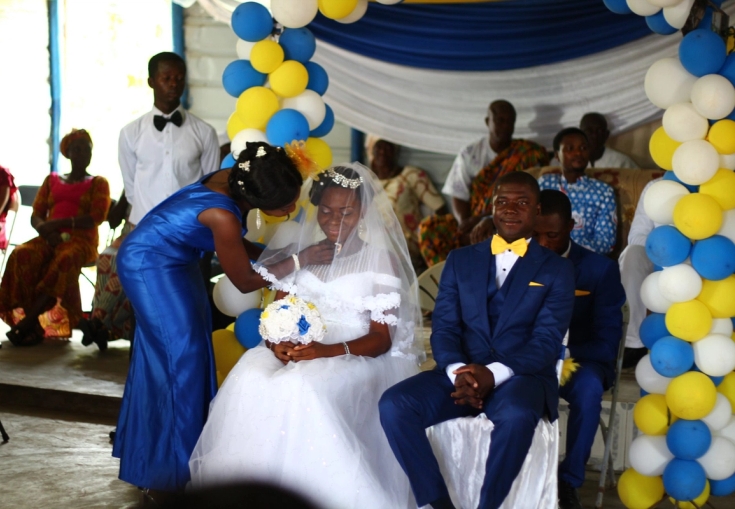 a bride and groom are sitting in chairs at a wedding ceremony.