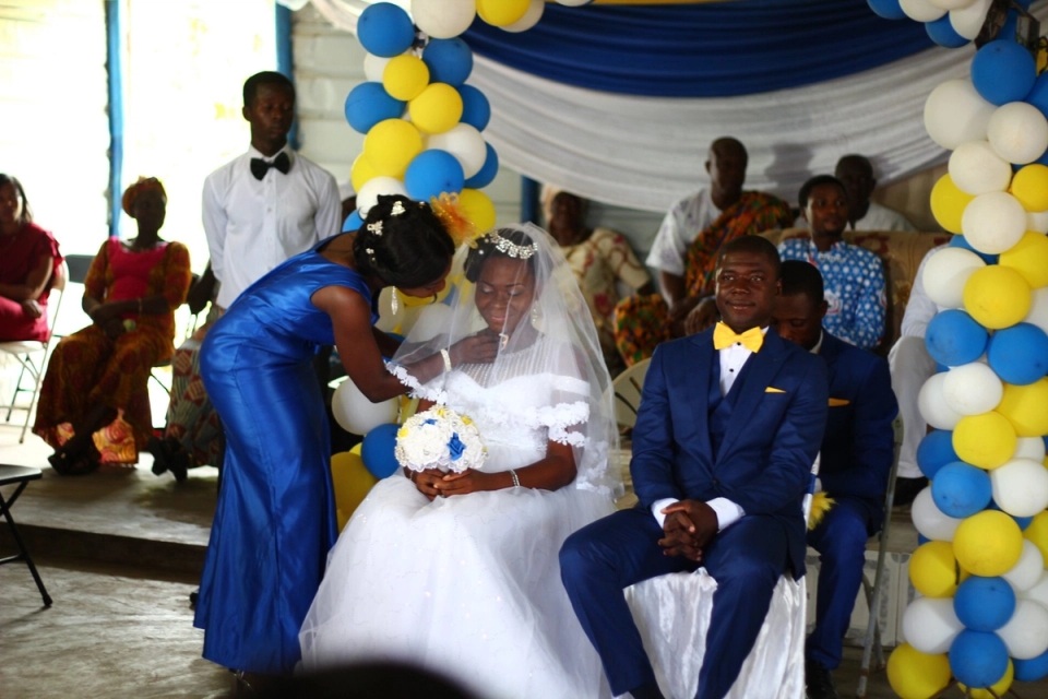 a bride and groom are sitting in chairs at a wedding ceremony.