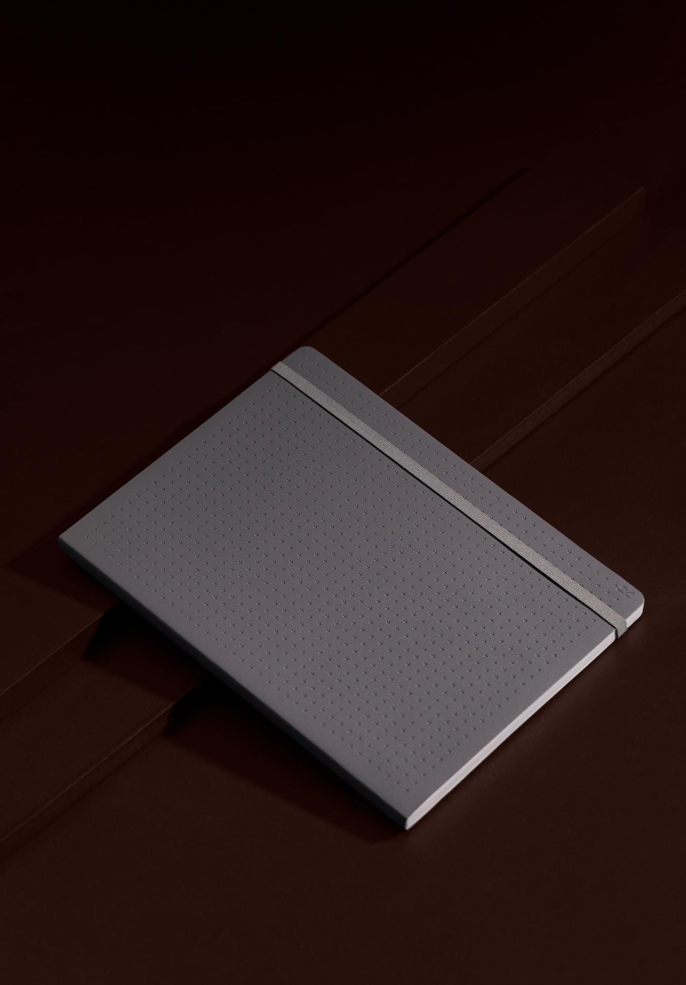 Debossed grey softcover with a subtle grid pattern – unmistakable on any desk, drafting table, or job site.