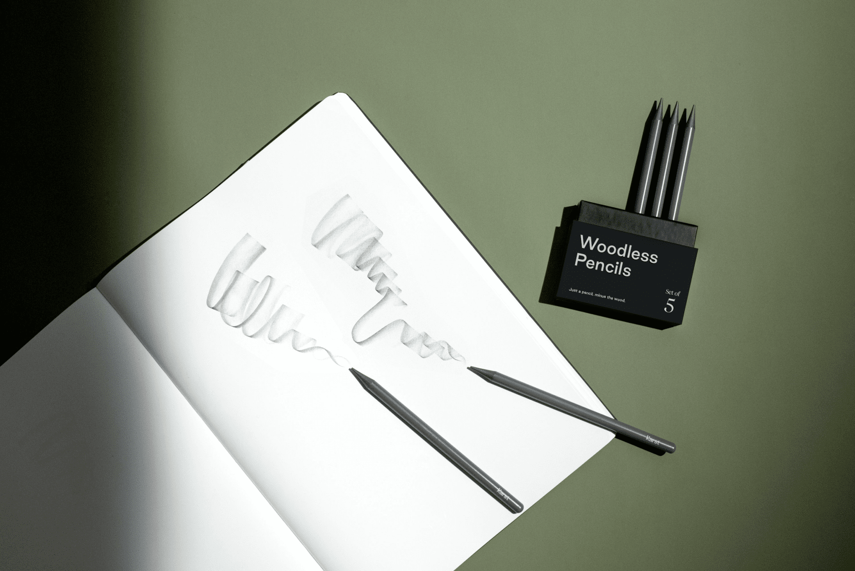 Karst woodless graphite pencils shown as a set of five solid graphite pencils with their reusable storage case