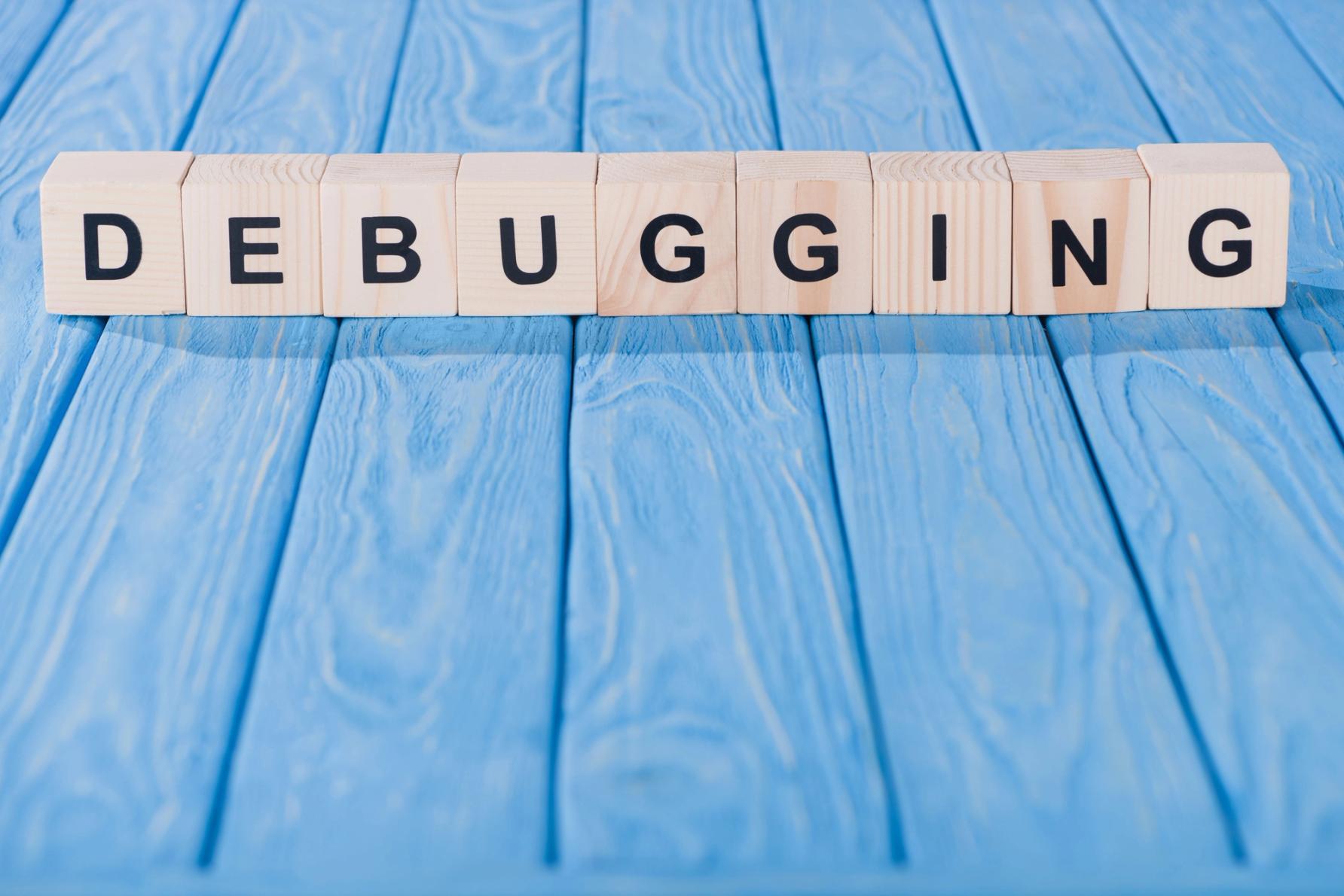 letter blocks spelling out the word debugging