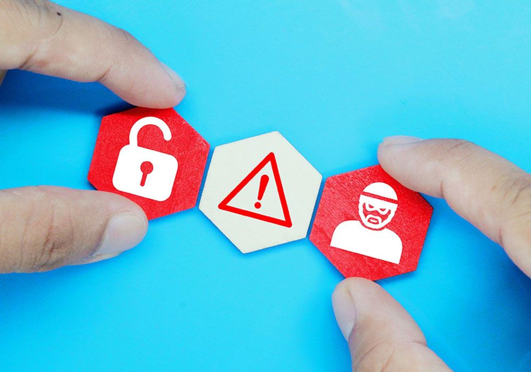 person holding icons representing cyber security threats