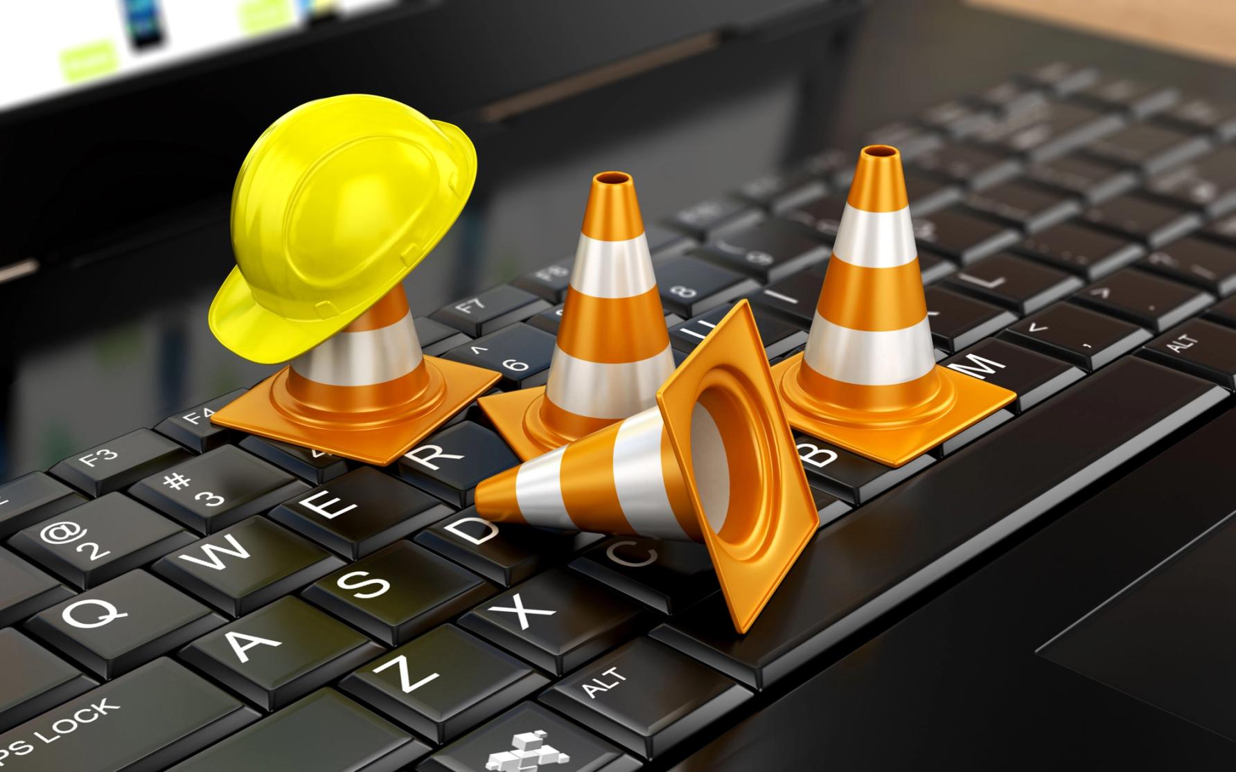 3d rendering of traffic cones on a computer keyboard