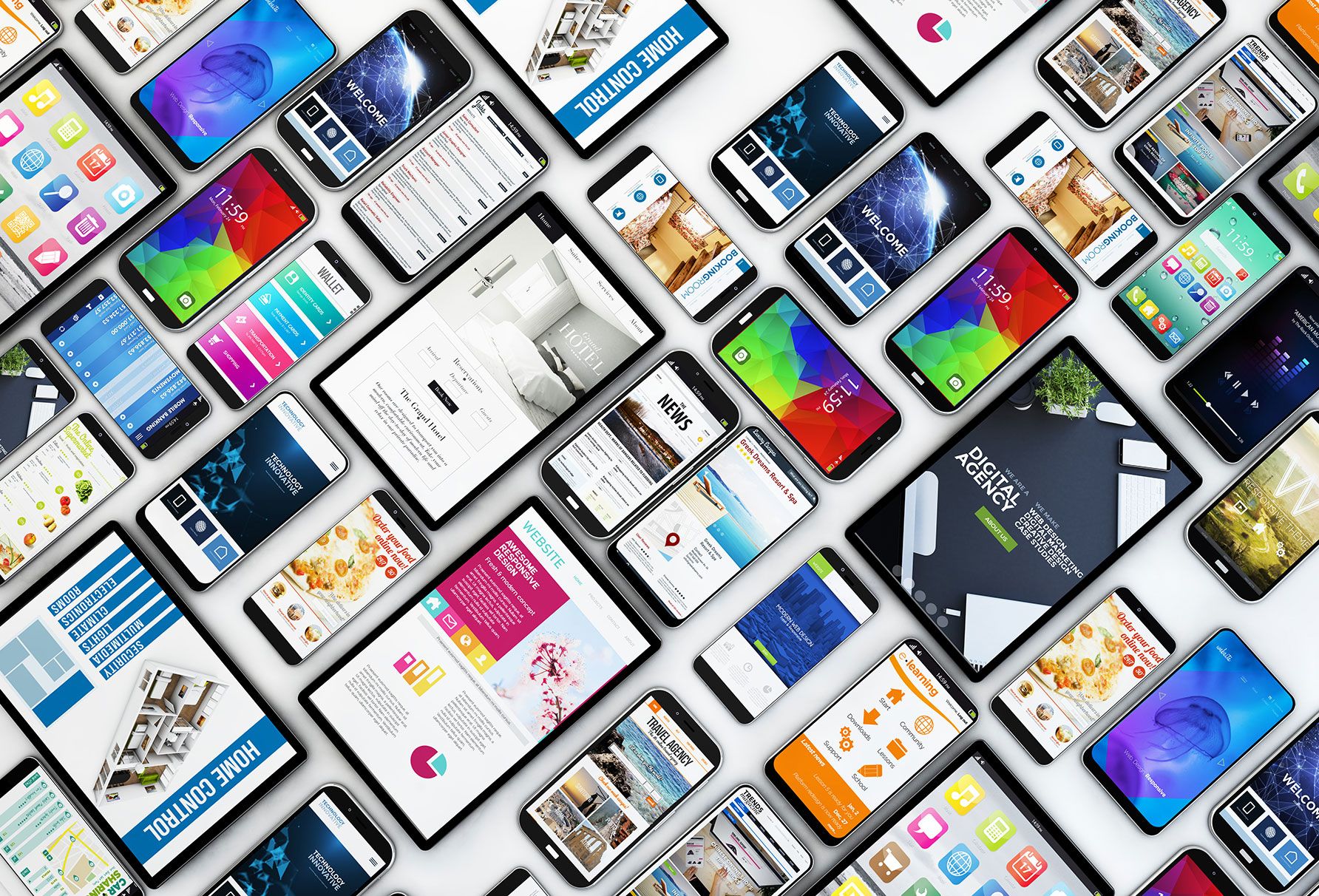 Dozens of mobile devices arranged on a flat surface showcasing the importance of mobile first design.