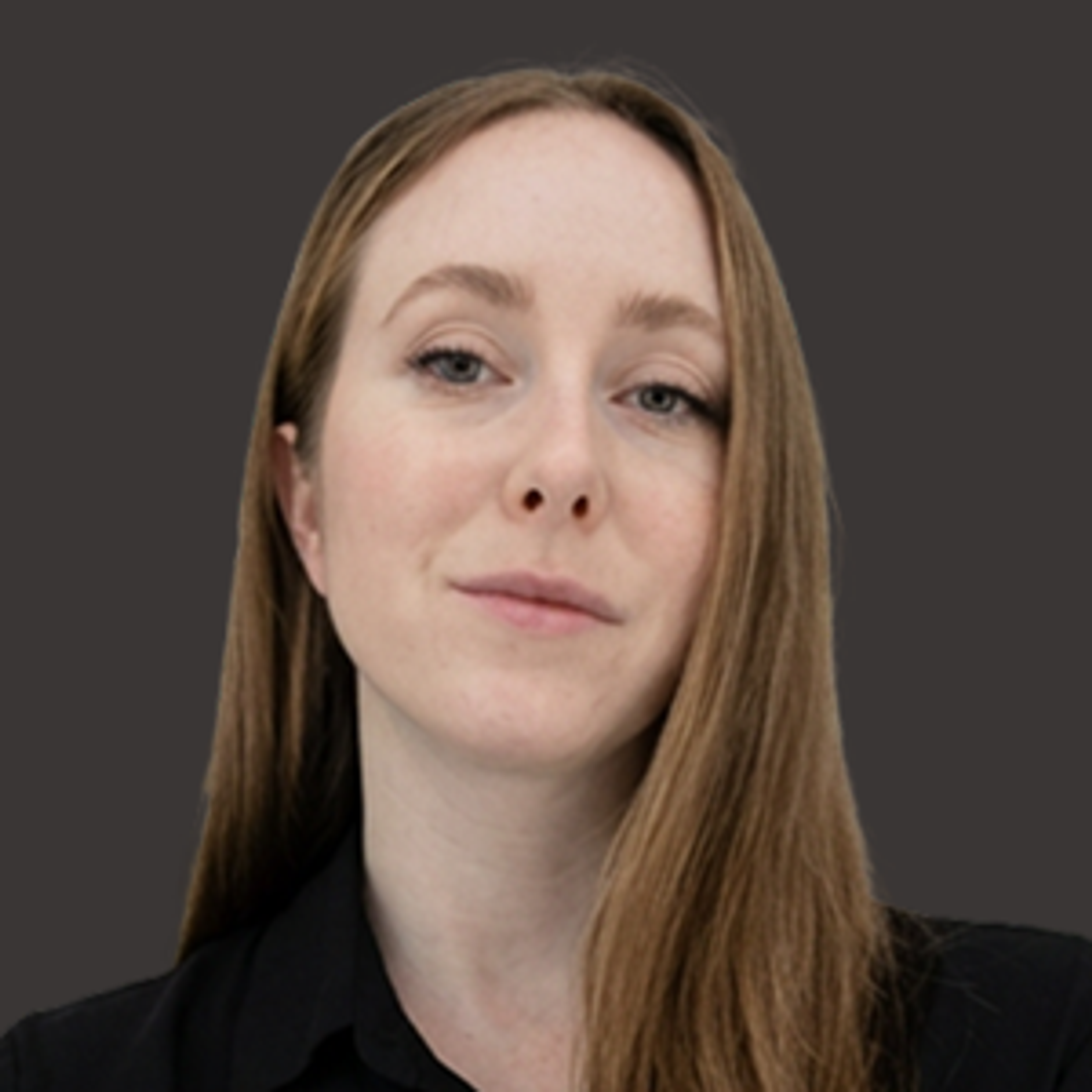 A woman with long light brown hair and fair skin looks at the camera with a neutral expression, wearing a black top against a plain dark background.