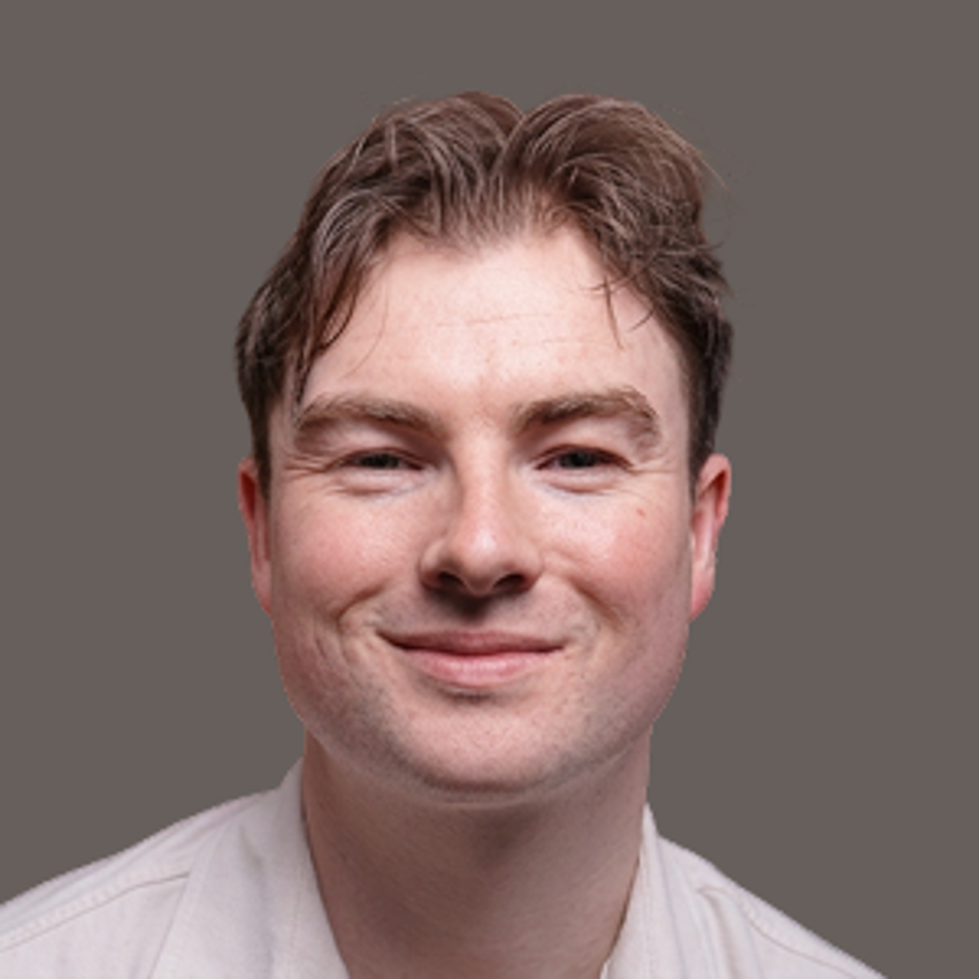 Headshot of a man smiling at the camera.