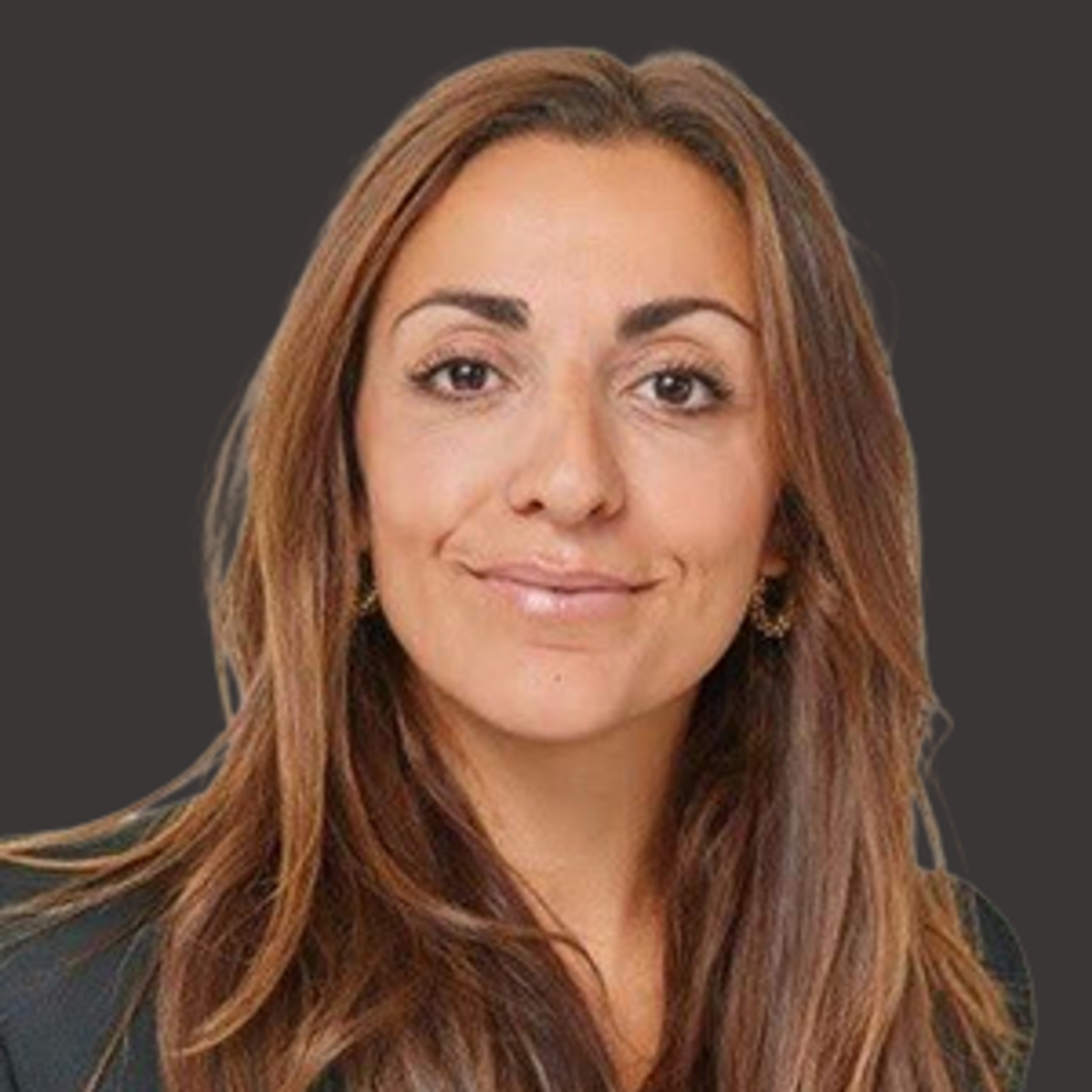 Woman with long brown hair and a black top, smiling slightly, shown against a plain dark background.