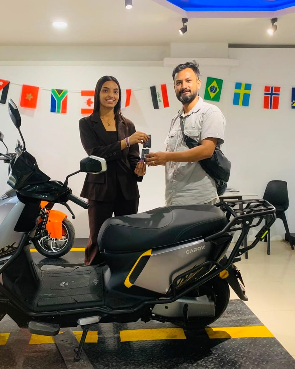 A customer beside their new electric scooter