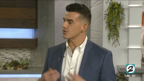 a GIF of Nick Wolny answering a question in a television interview