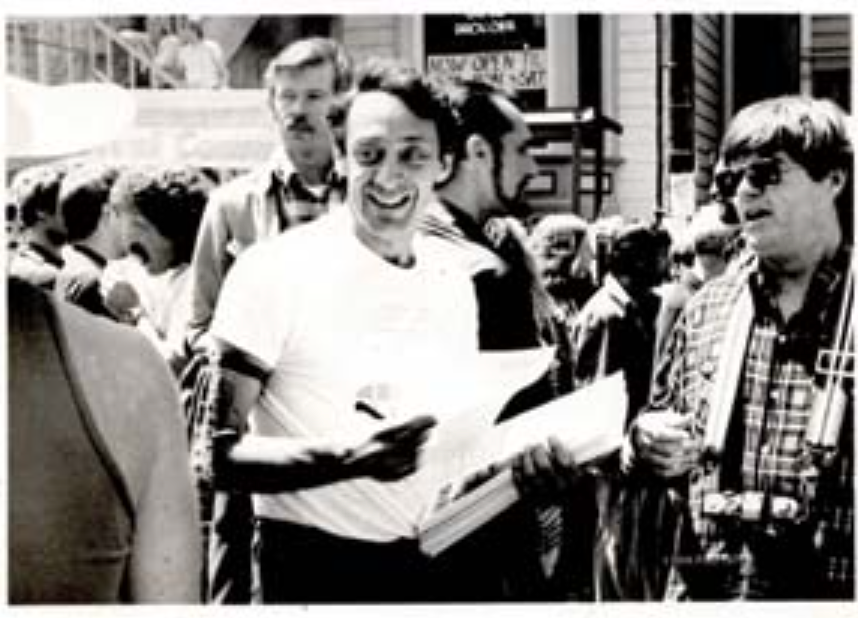harvey milk in a white t shirt at the castro street fair