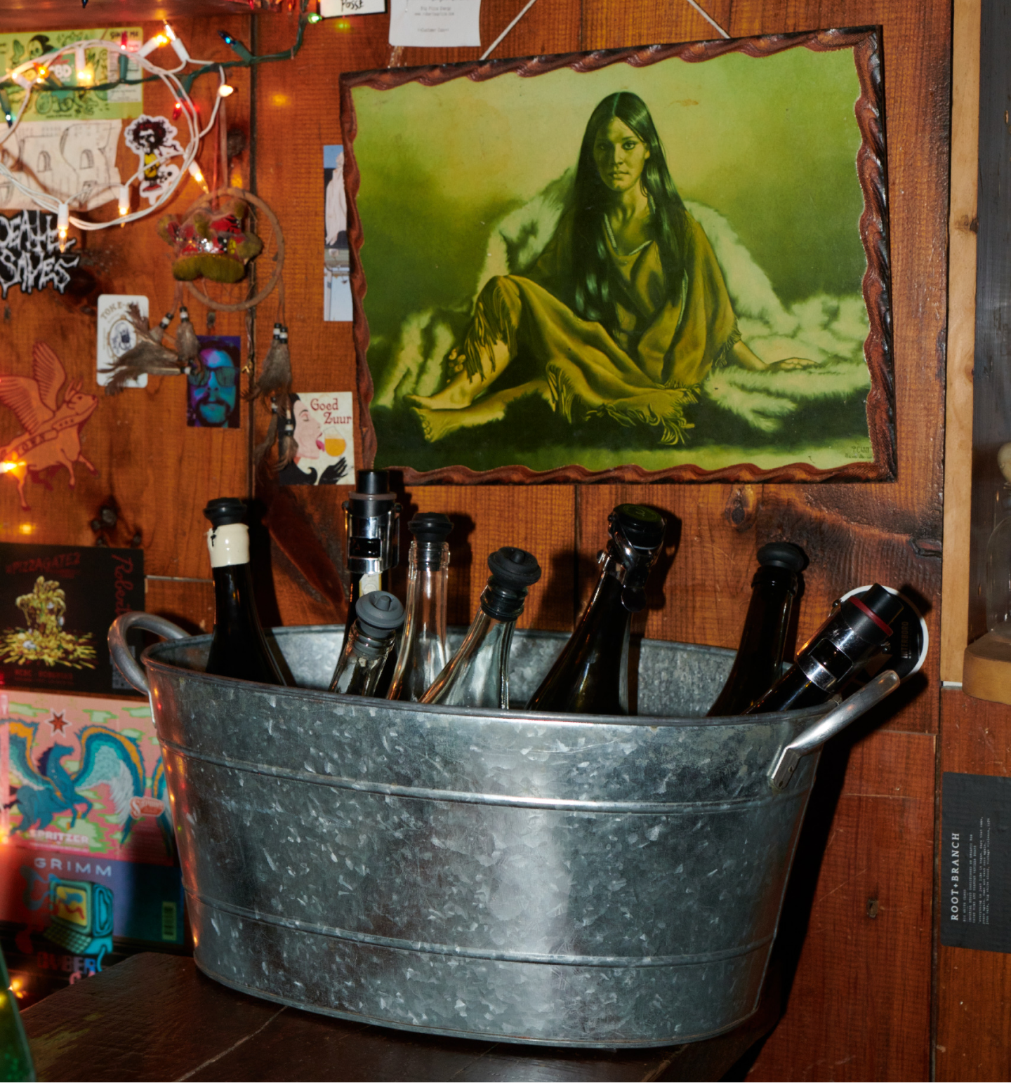 photograph of wine bucket with a painting of a woman above