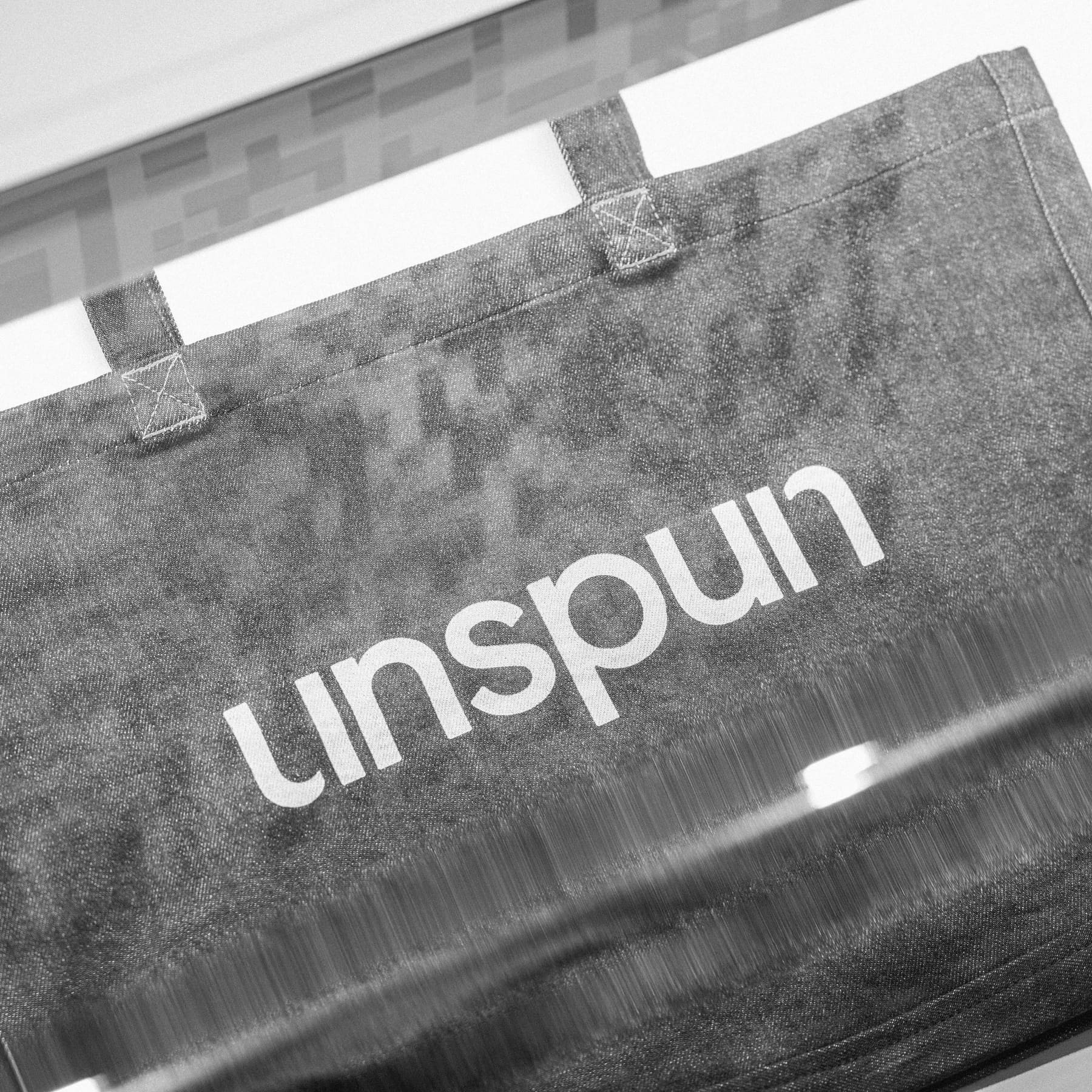 unspun logo printed on bag in black and white