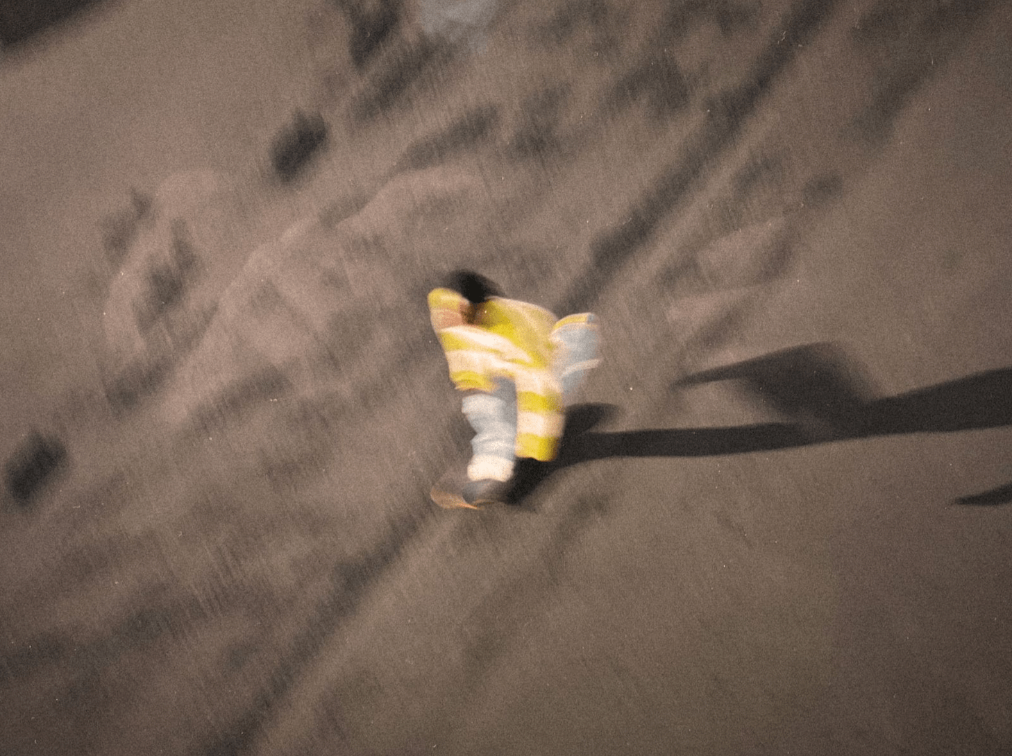 blurred photo of a skateboarder in motion