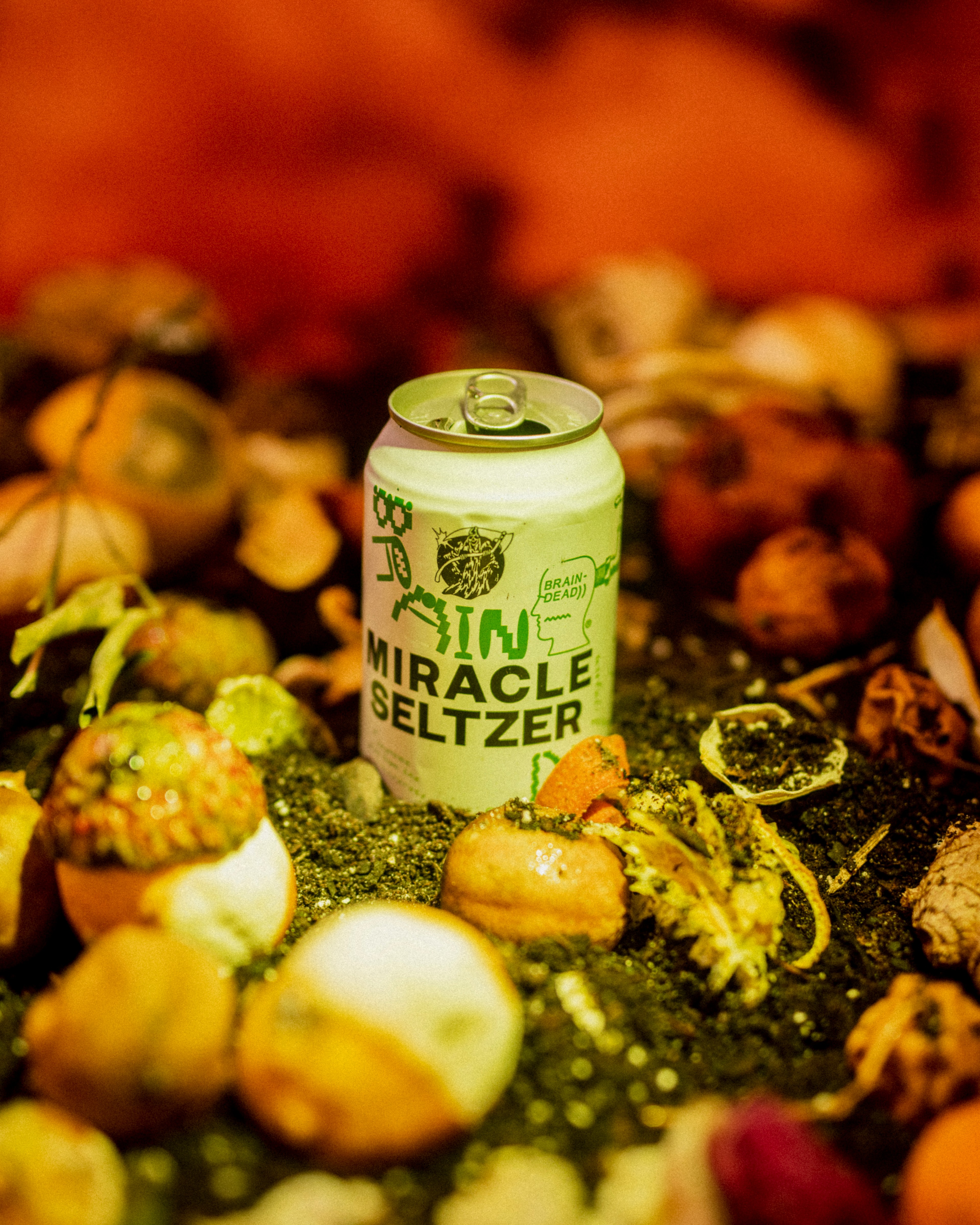 photo of miracle seltzer can surrounded by mushrooms