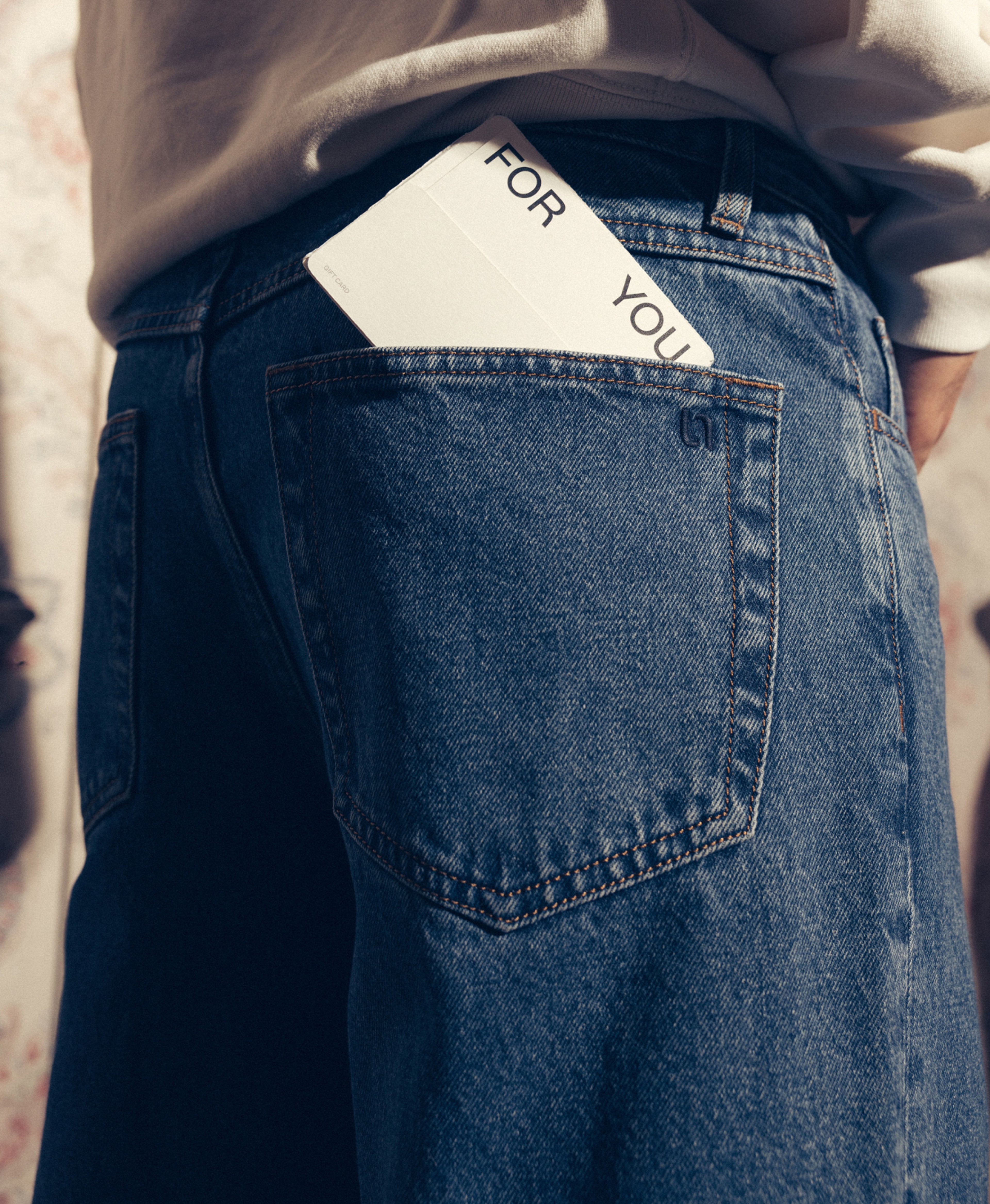 unspun jeans with card reading "for you" in back pocket