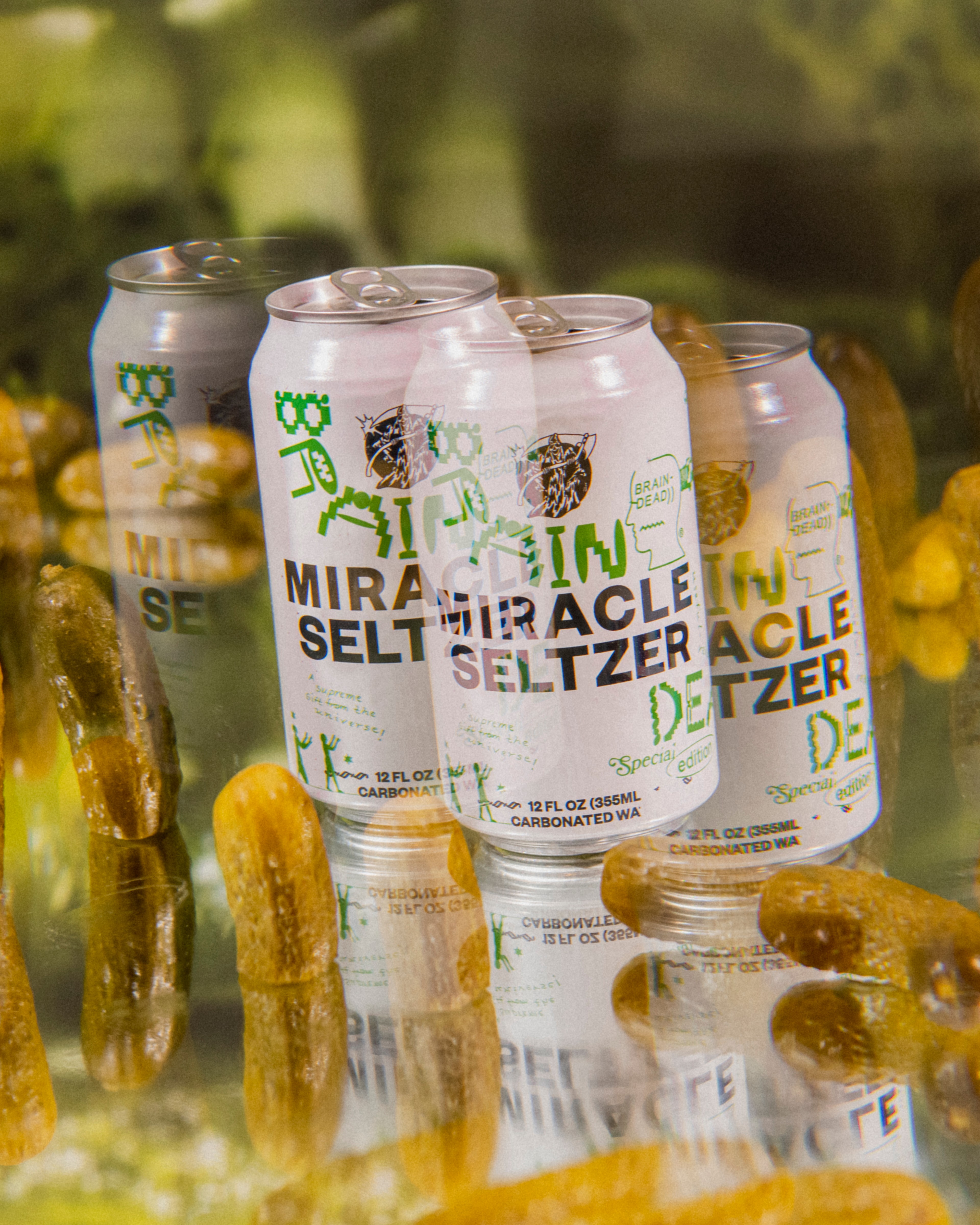 photo of a miracle seltzer can with pickles next to it shot through a prism