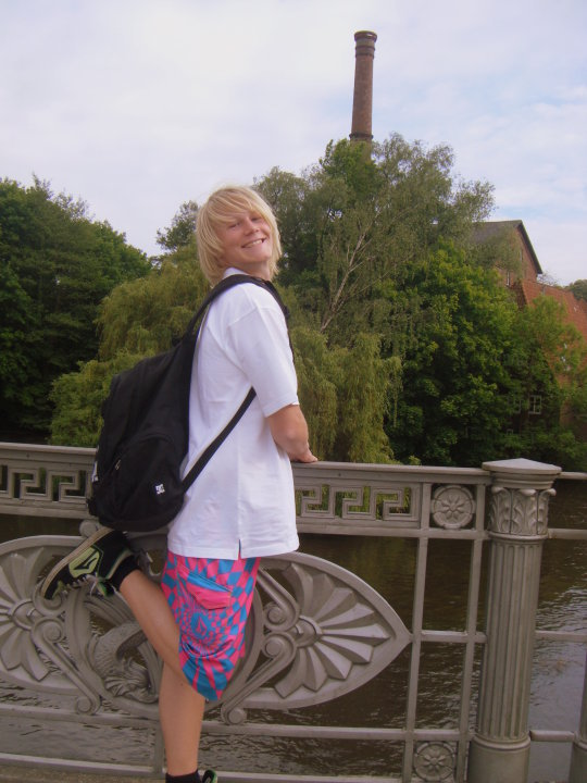 Young guy in oversized clothes posing for camera