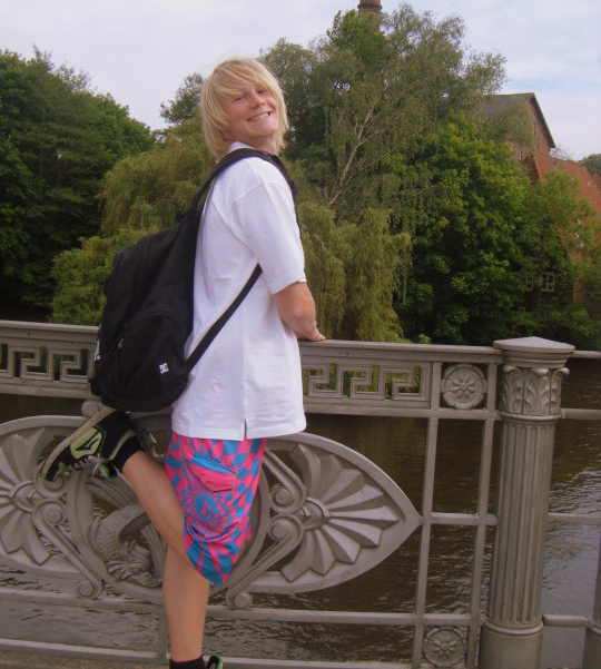 Young guy in oversized clothes posing for camera