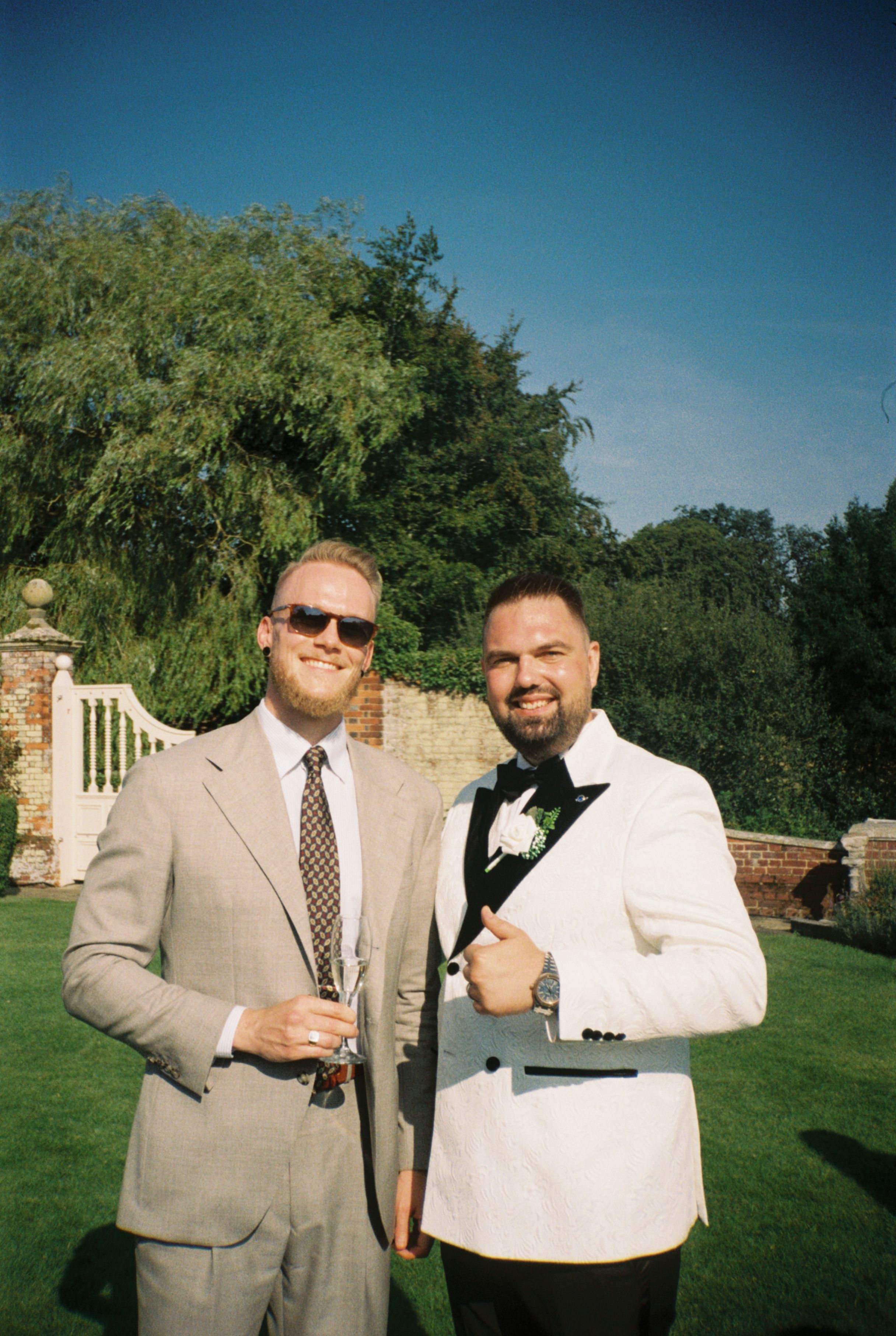 Kristoffer wearing a light suit with a white shirt and brown tie.