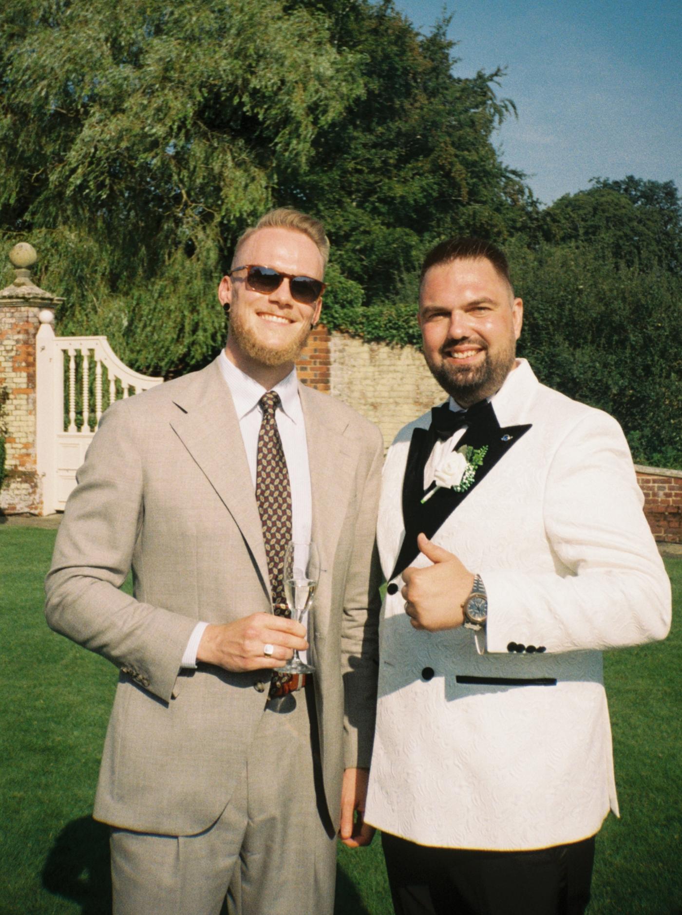 Kristoffer wearing a light suit with a white shirt and brown tie.