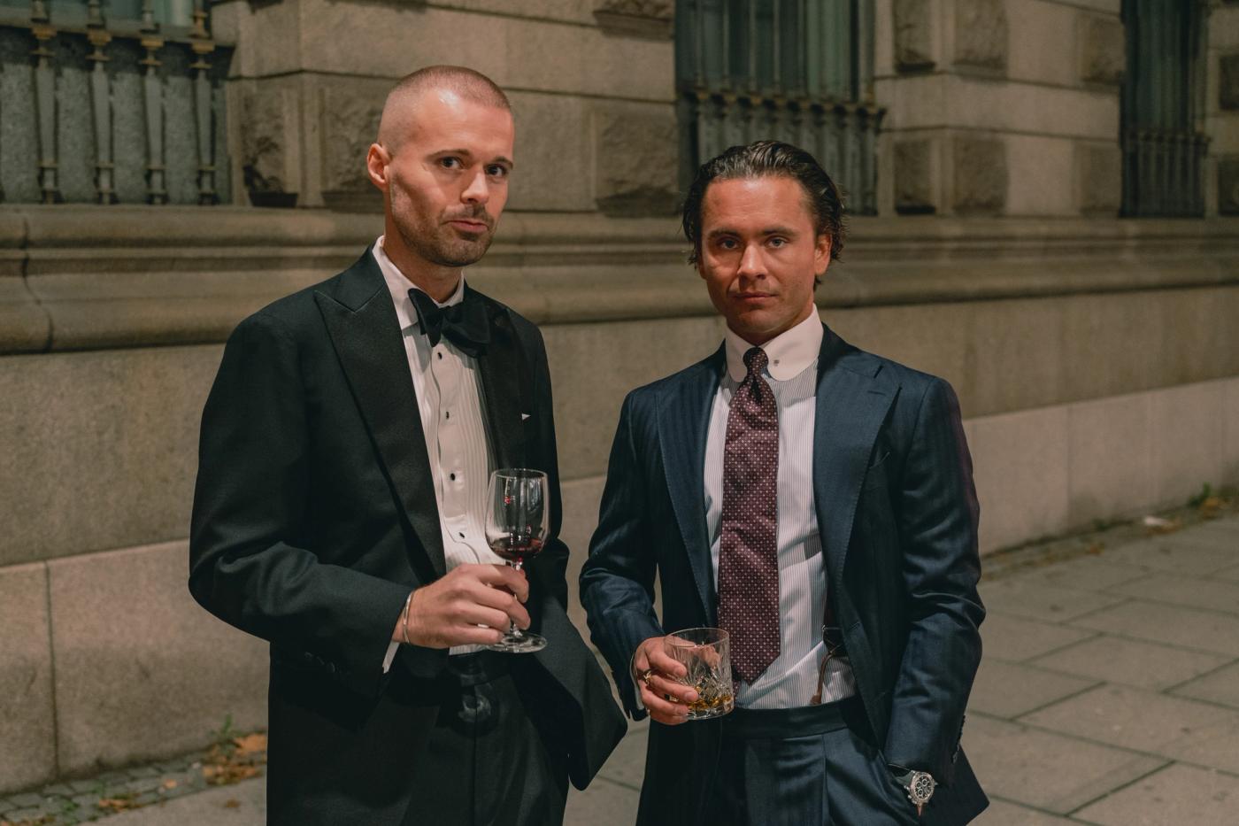 Two well dressed men posing for the camera