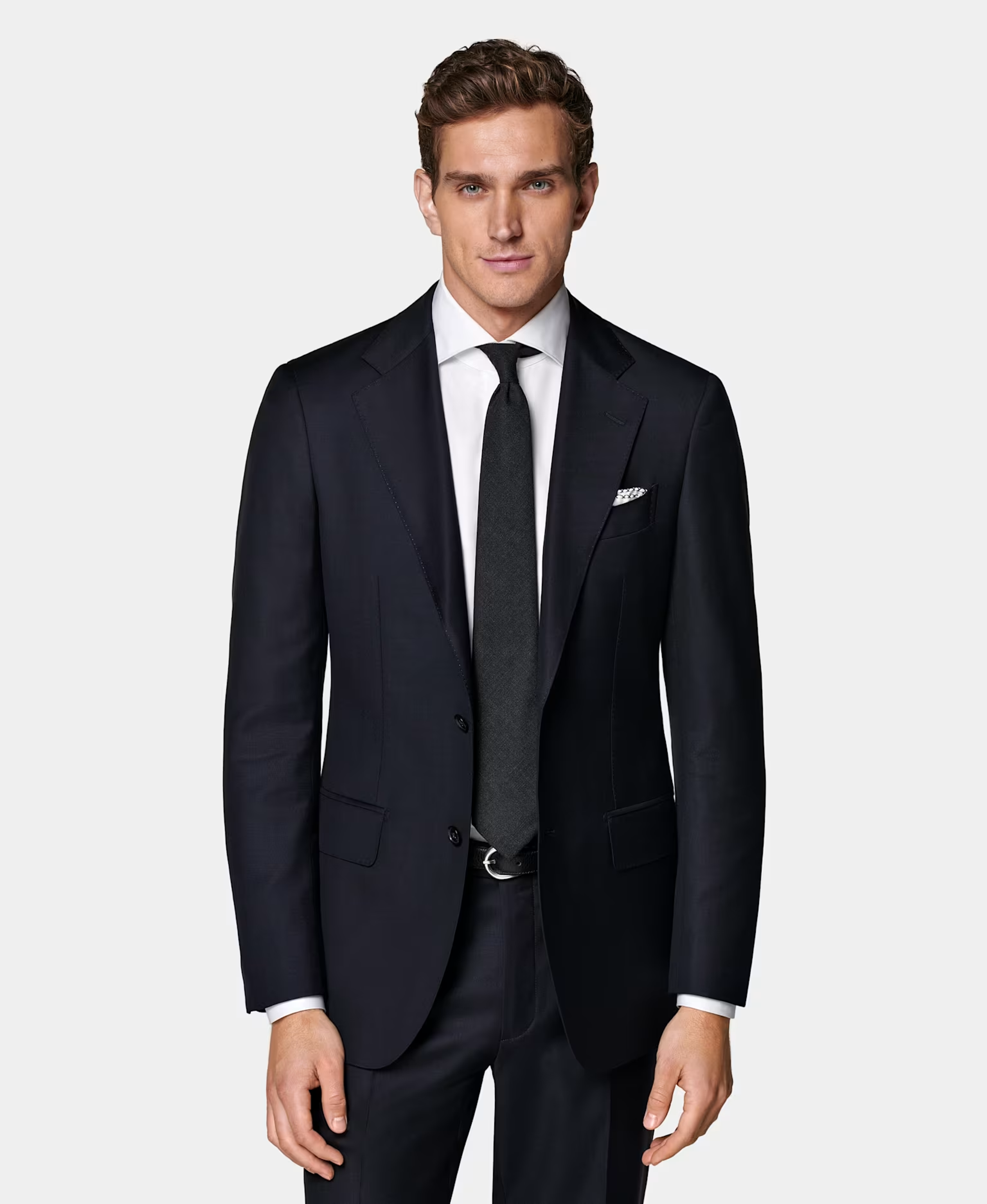 Man in midnight blue suit, white shirt and neutral tie