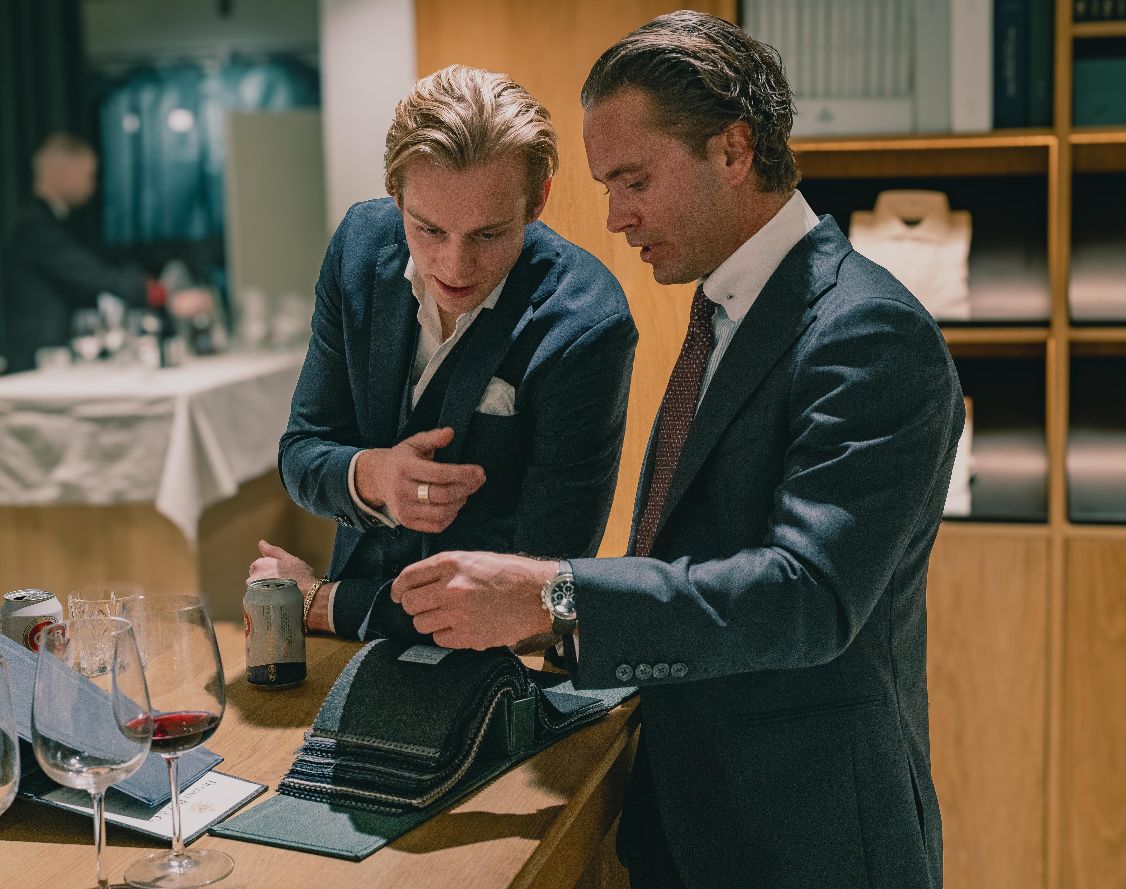 Two men looking at fabrics