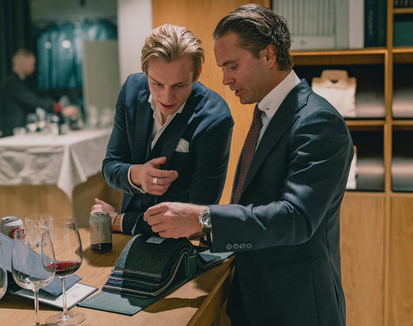 Two men looking at fabrics