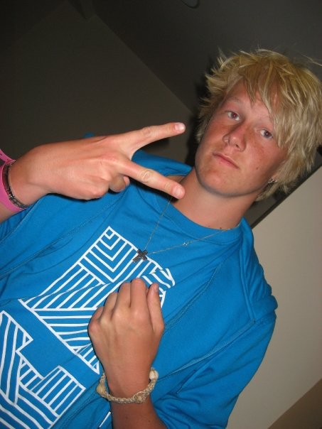 Young guy in oversized t-shirt doing a hand sign