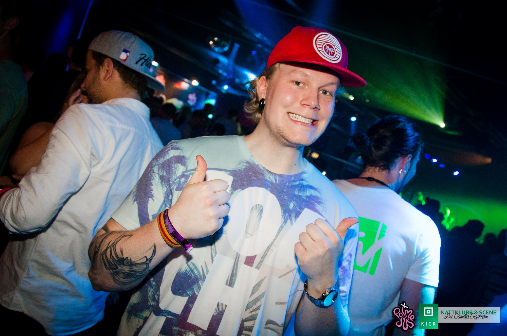 Young guy in colorful outfit giving thumbs up