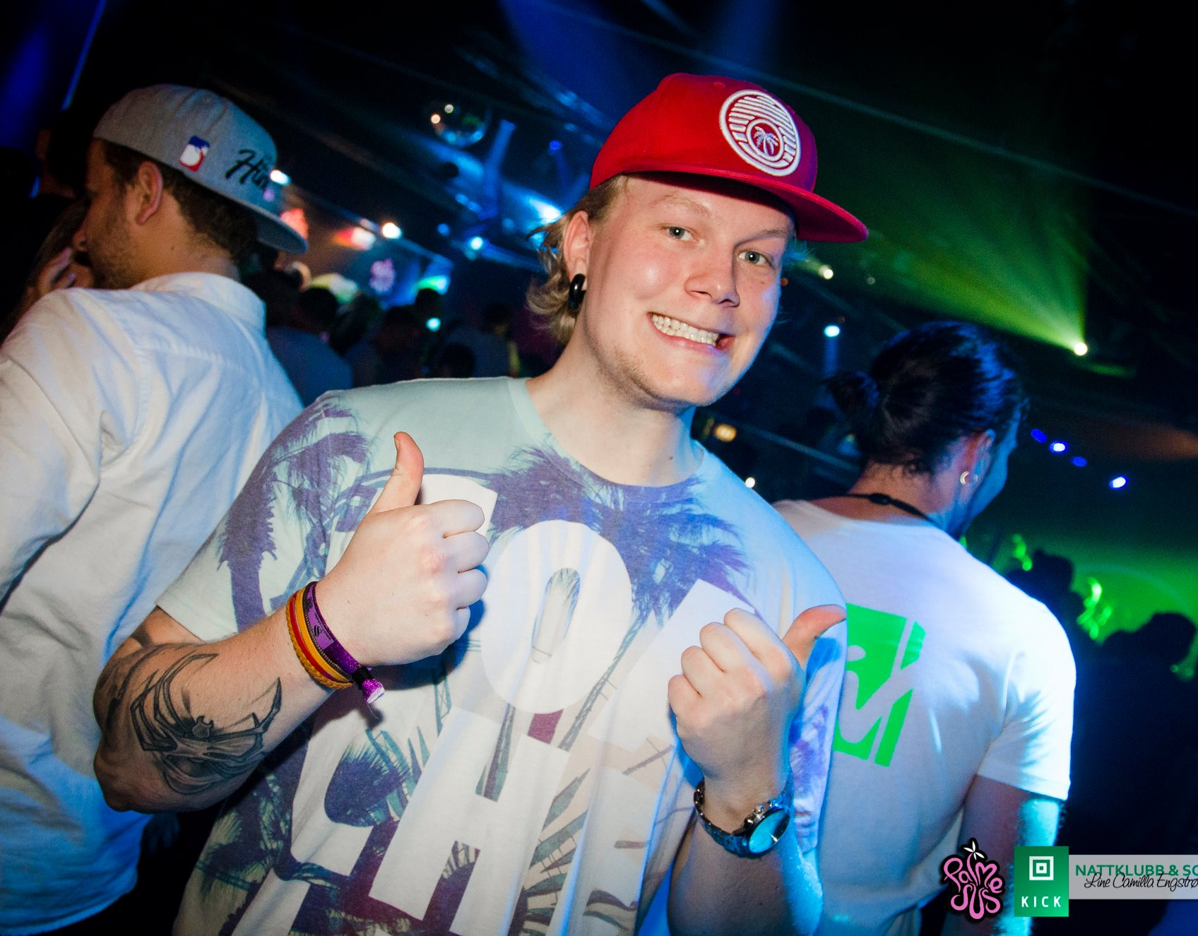 Young guy in colorful outfit giving thumbs up