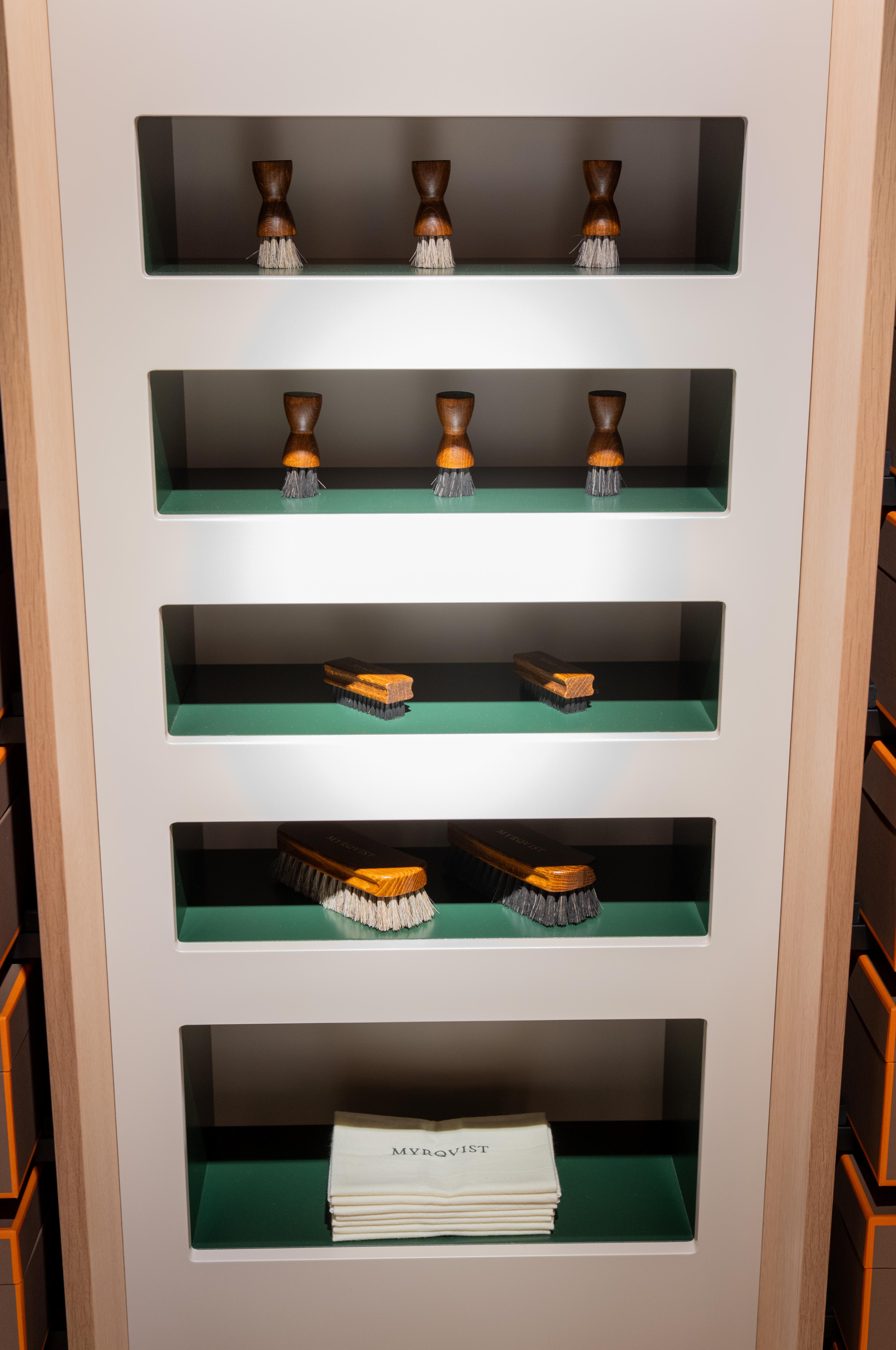 a shelf with brushes and a towel that says myrqvist on it