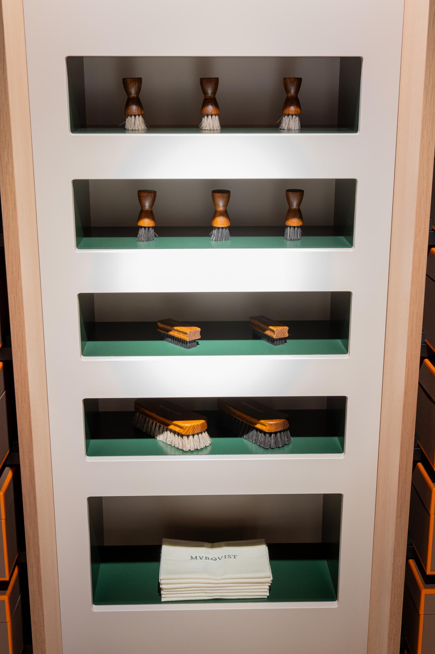 a shelf with brushes and a towel that says myrqvist on it