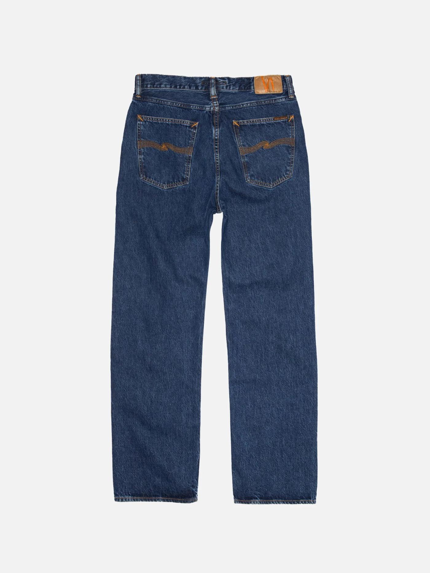 Back view of dark blue jeans with orange stitching on the back pockets and a brown leather waist patch.